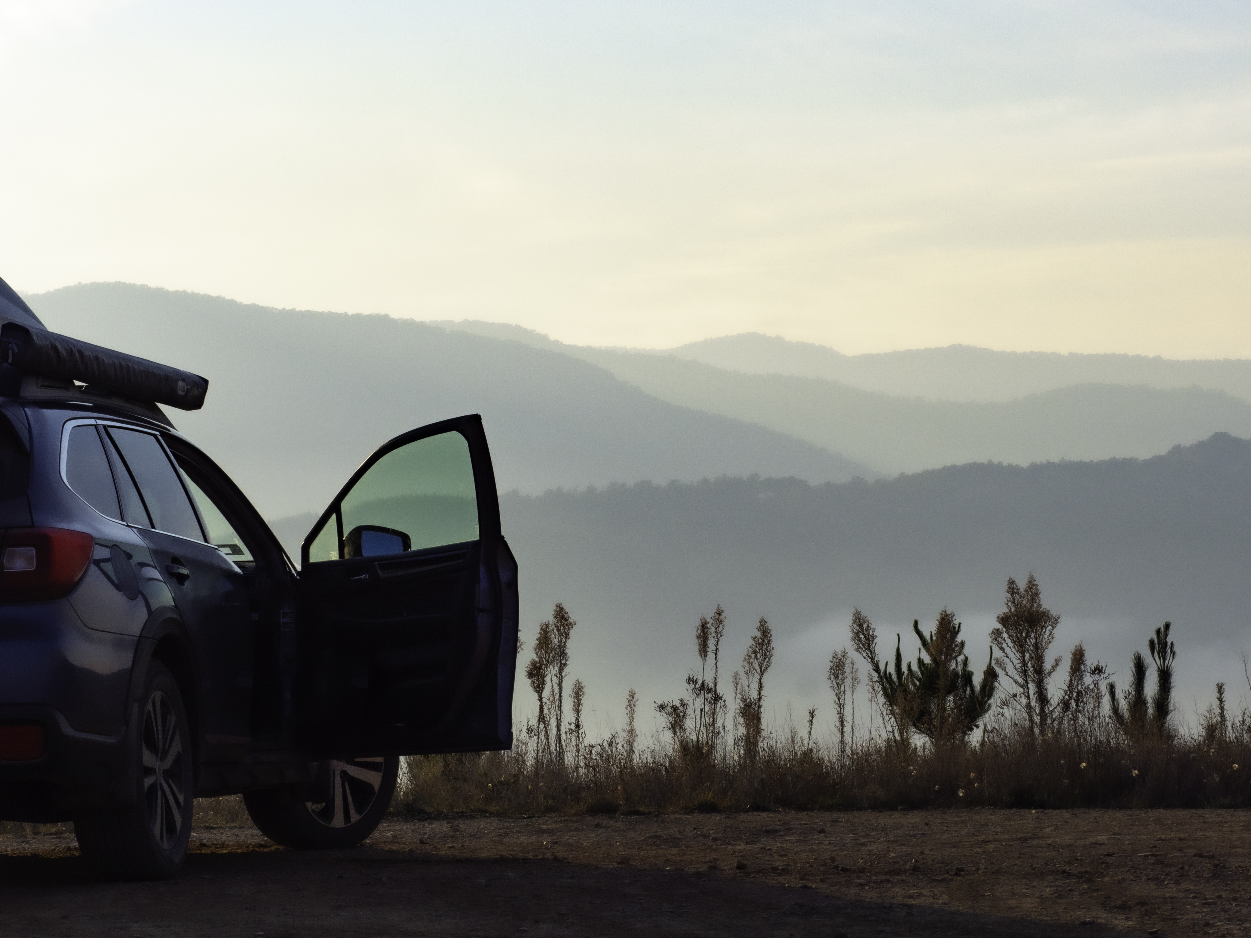 Car-with-door-open-looking-at-early-morning-mountain-views-2158341444_5109x3832